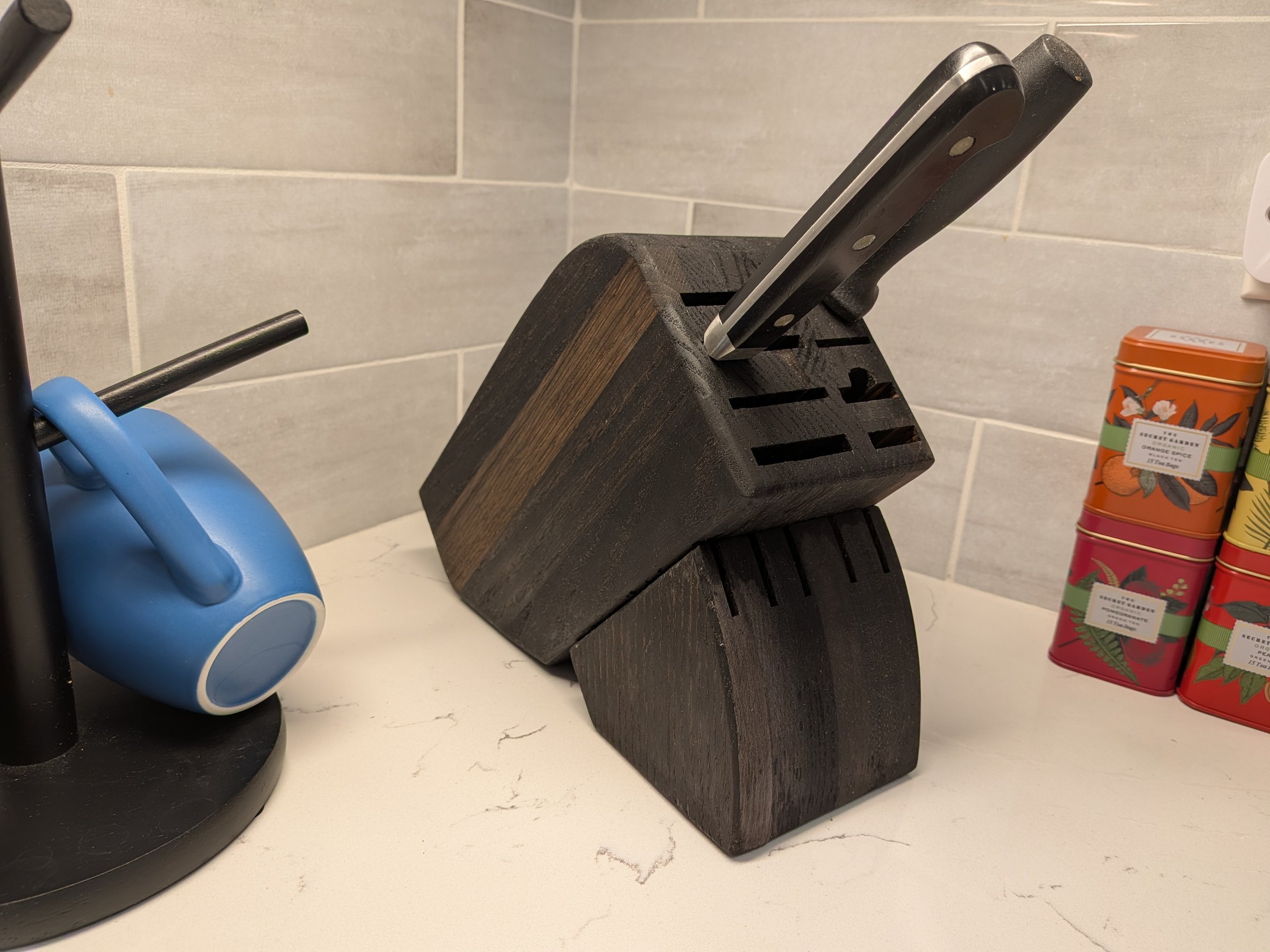 Handmade two-tone wood knife block on a kitchen counter