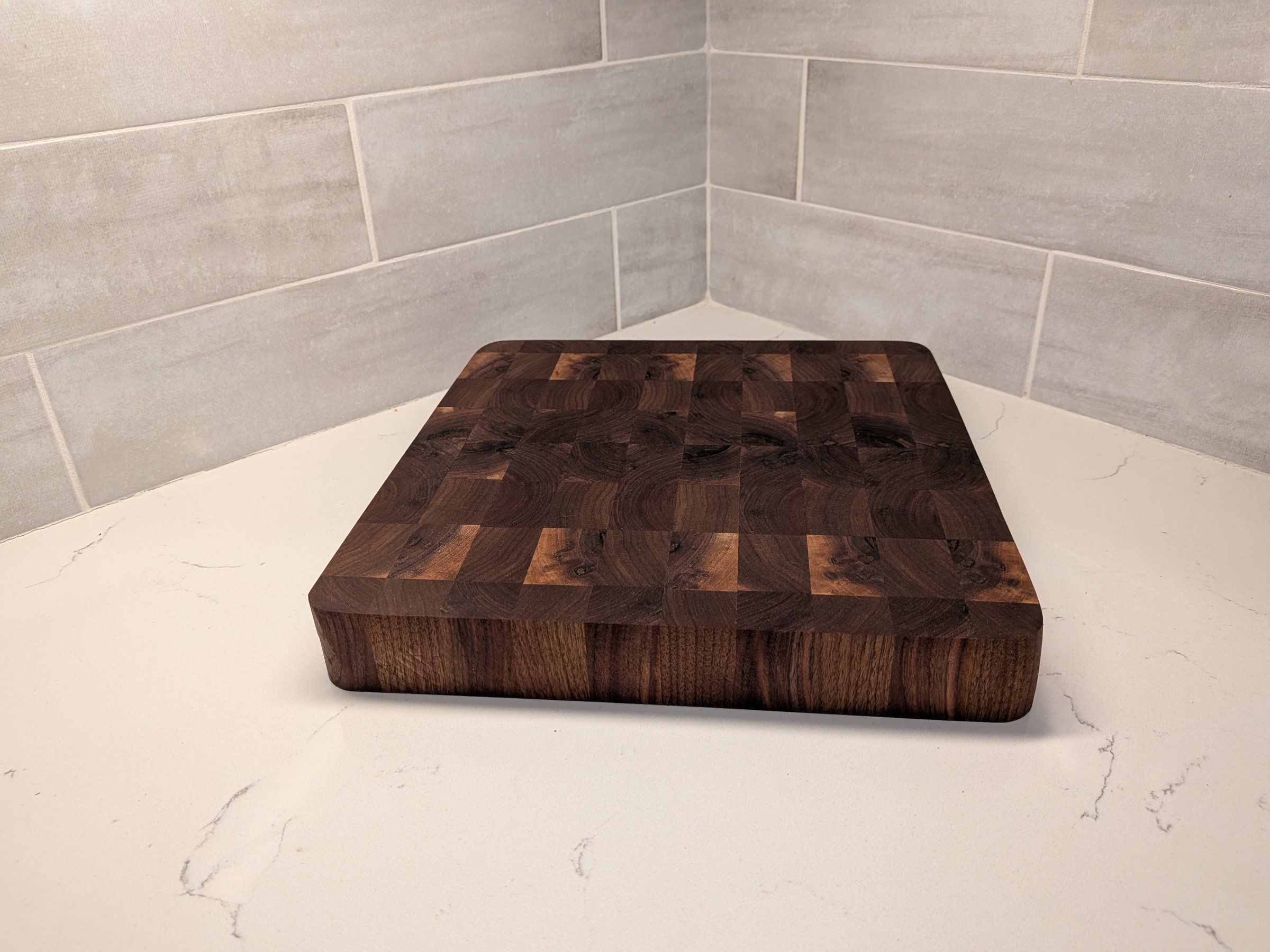 Solid walnut end-grain cutting board with rich swirling grain