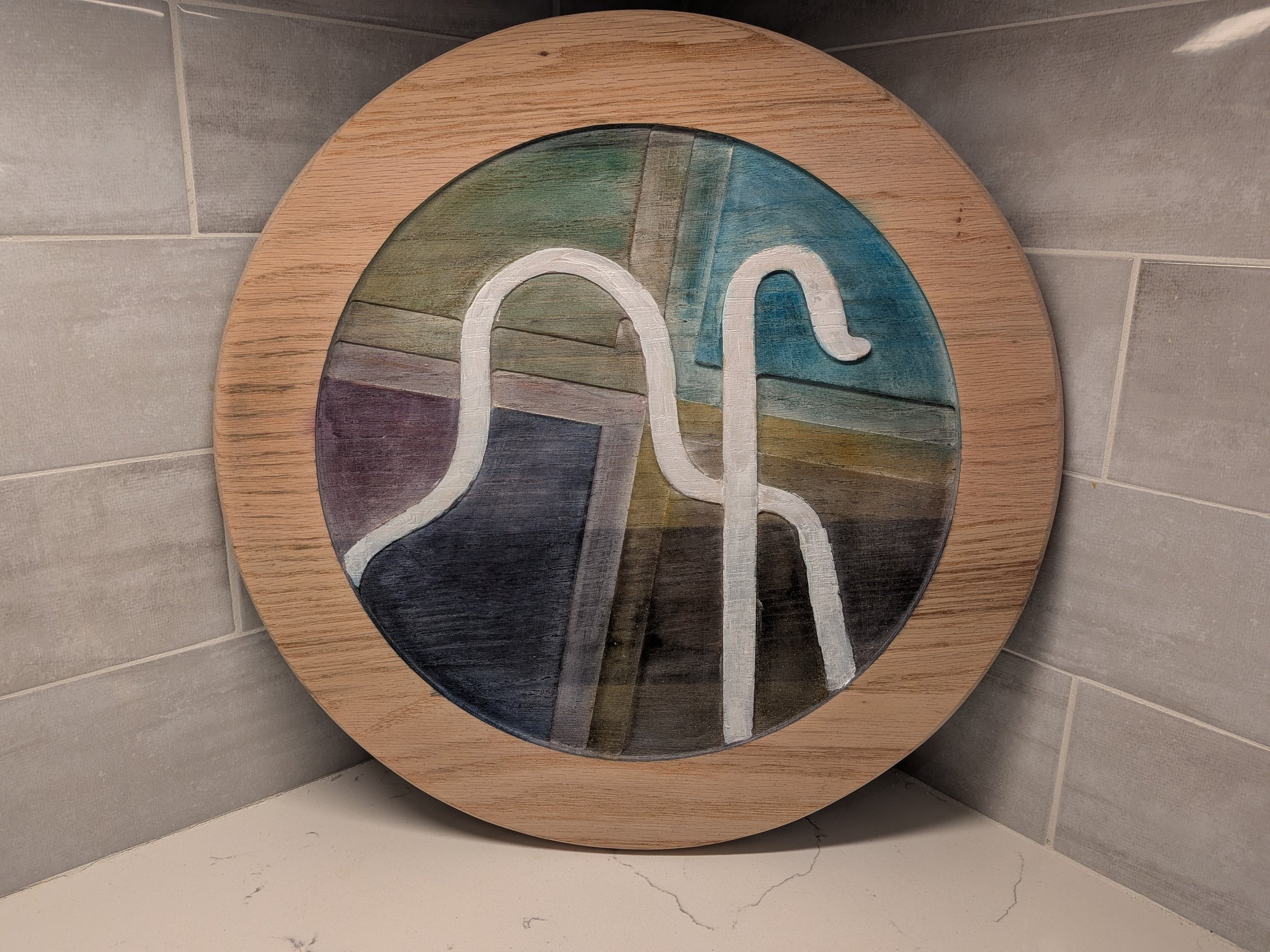 Round painted wood panel with an abstract design